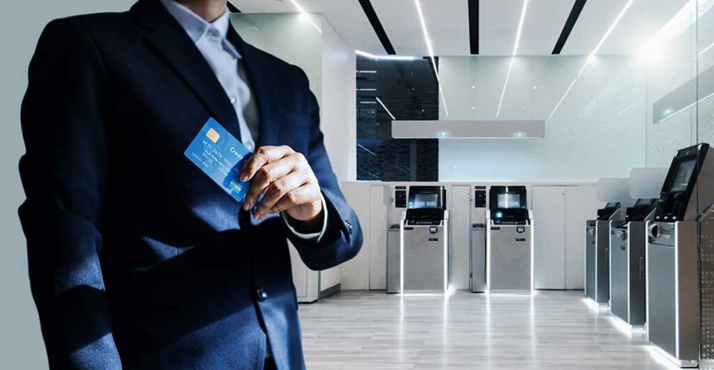 Person reviewing a banking app beside a wallet with a missing debit card slot and handwritten transaction notes.