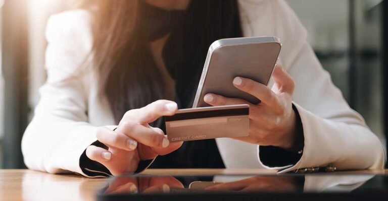 A couple reviews retirement statements and a household budget at a kitchen table.